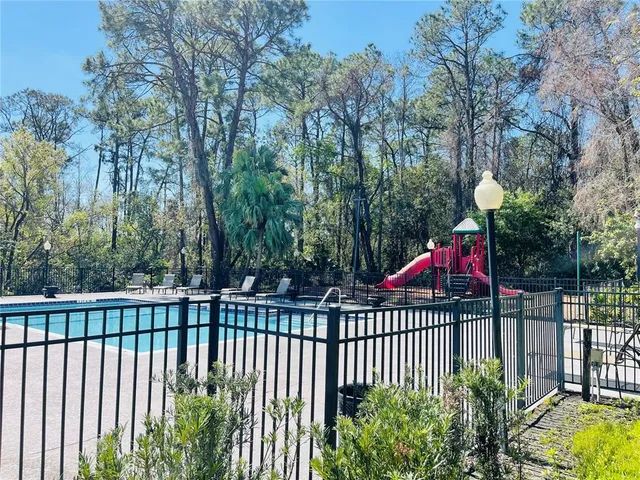 a swimming pool with outdoor seating and yard