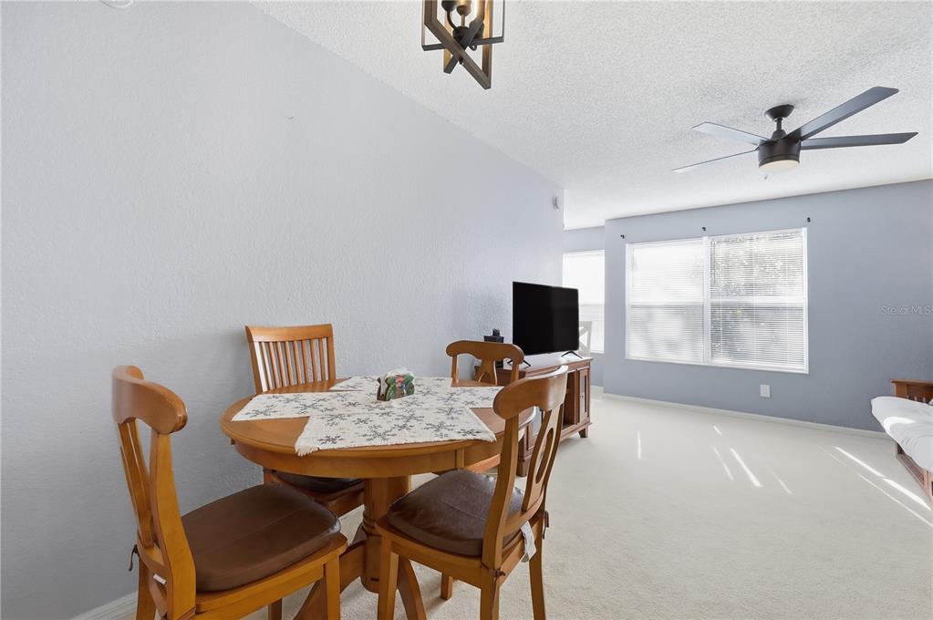 5108 Conroy Road, Unit 1724 Orlando, FL 32811 - Photo 15 of 40 a view of a dining room with furniture