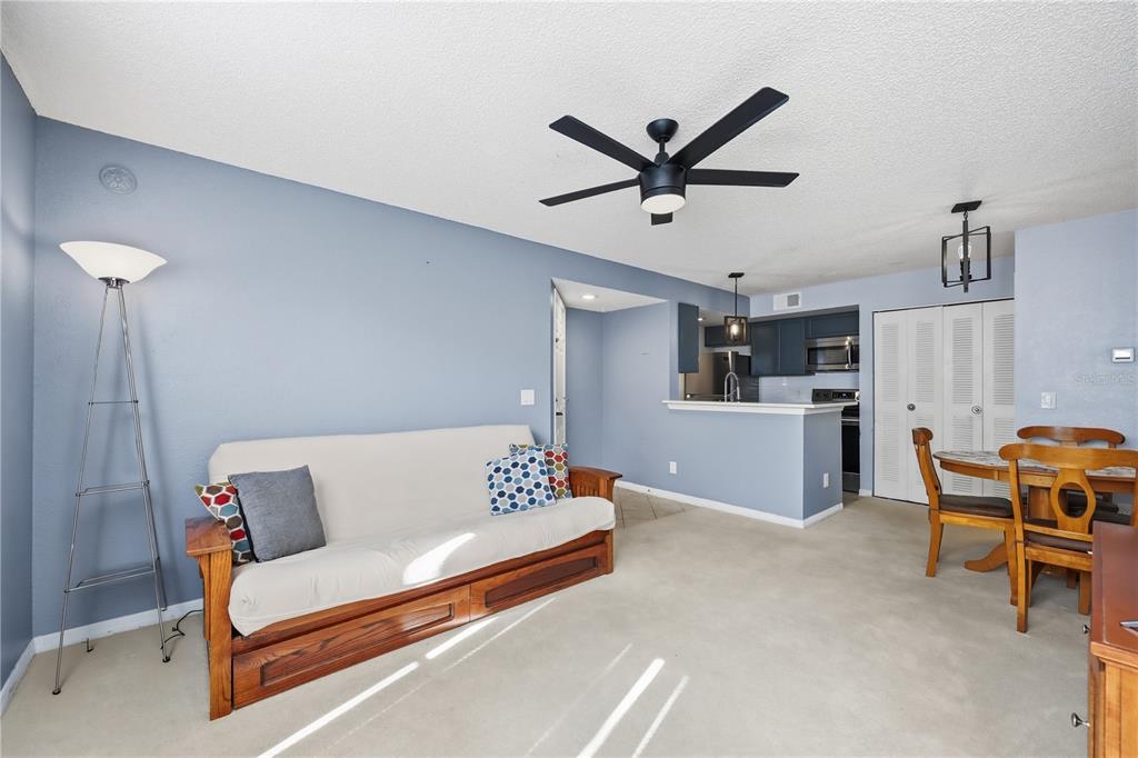 5108 Conroy Road, Unit 1724 Orlando, FL 32811 - Photo 16 of 40 a living room with furniture and a dining table