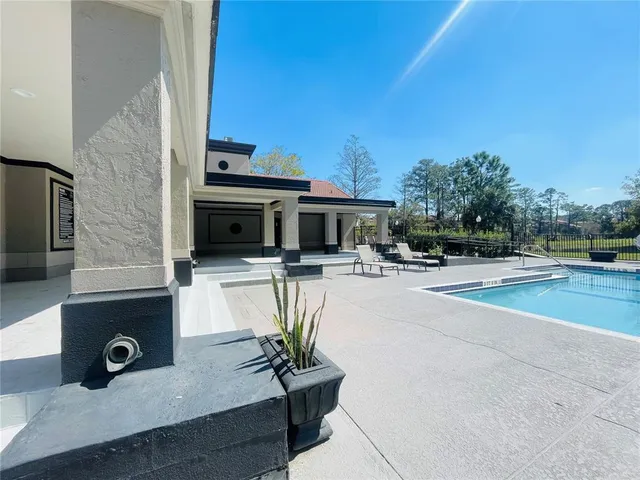 a view of a swimming pool with a patio
