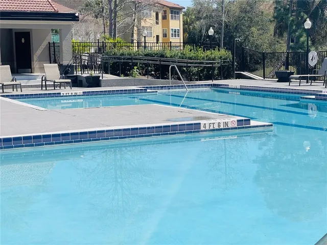 a view of a houses with swimming pool and porch