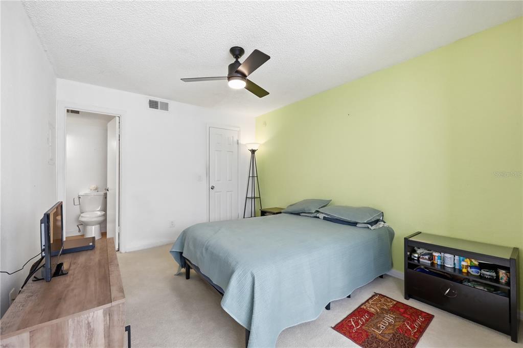 5108 Conroy Road, Unit 1724 Orlando, FL 32811 - Photo 20 of 40 a bedroom with a bed and furniture