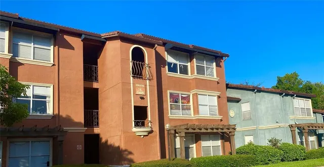 a front view of a residential apartment building with a yard