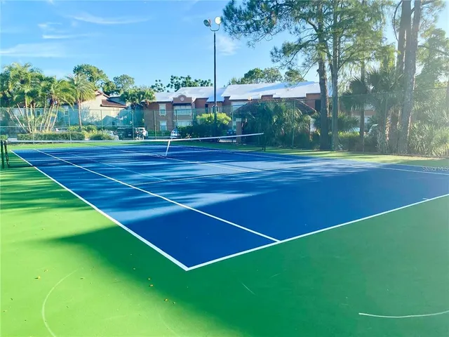 a view of a patio with table and chairs with wooden floor to ceiling window