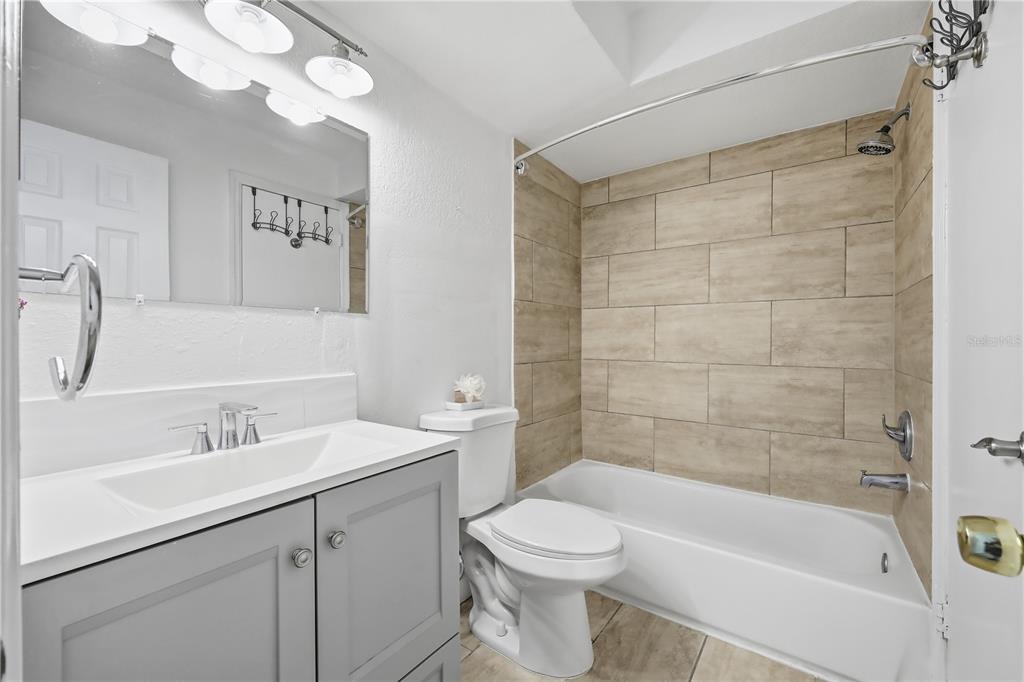 5108 Conroy Road, Unit 1724 Orlando, FL 32811 - Photo 22 of 40 a bathroom with a sink a toilet and shower