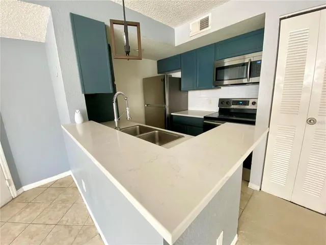 a kitchen with stainless steel appliances a refrigerator and a stove