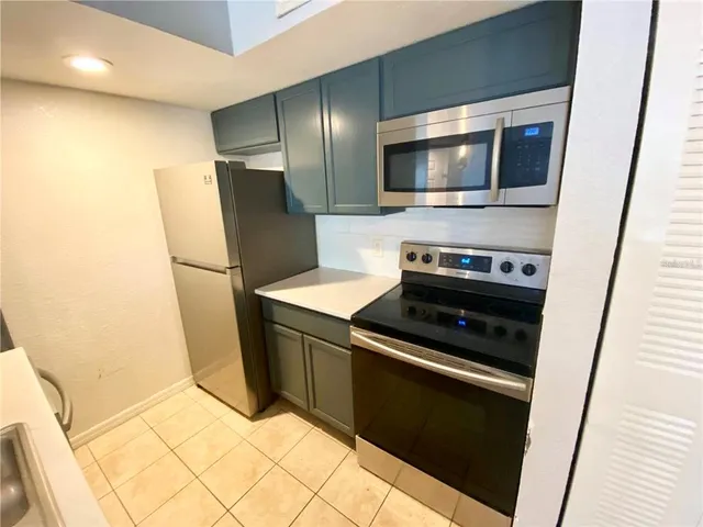 a kitchen with stainless steel appliances a refrigerator a stove and a microwave