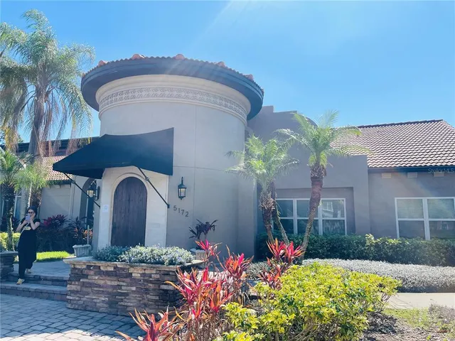 a view of swimming pool with furniture and wooden floor