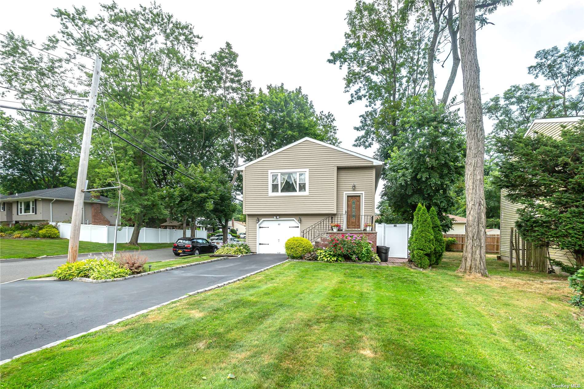 a sign board with a big yard and large trees