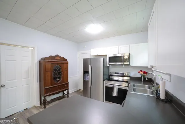 a kitchen with stainless steel appliances a stove and a refrigerator