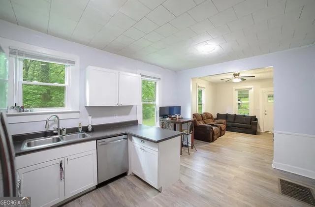 a kitchen with sink cabinets and wooden floor