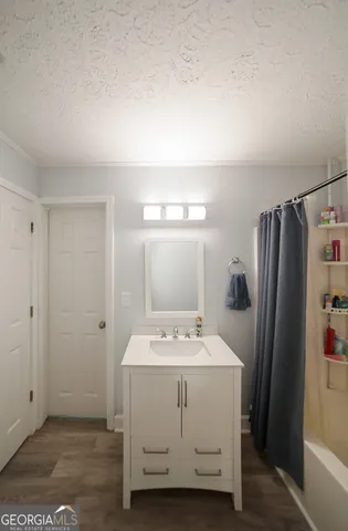a room with a sink and a refrigerator