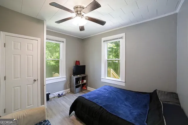 a bedroom with a bed and a window