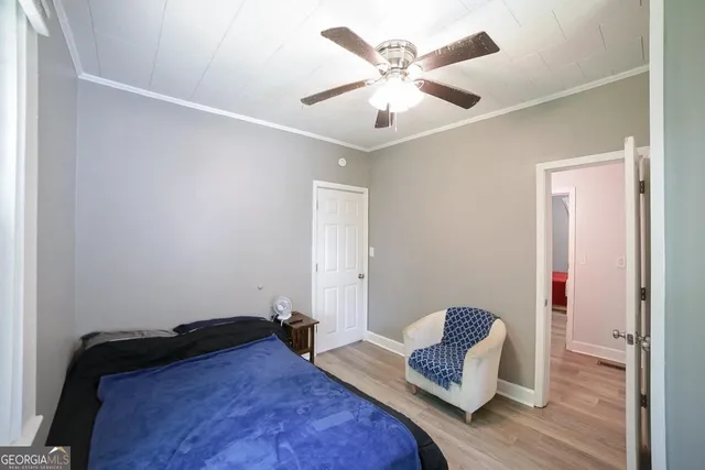 a living room with furniture and a ceiling fan
