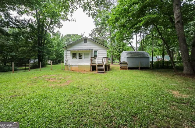 a view of house with yard and green space