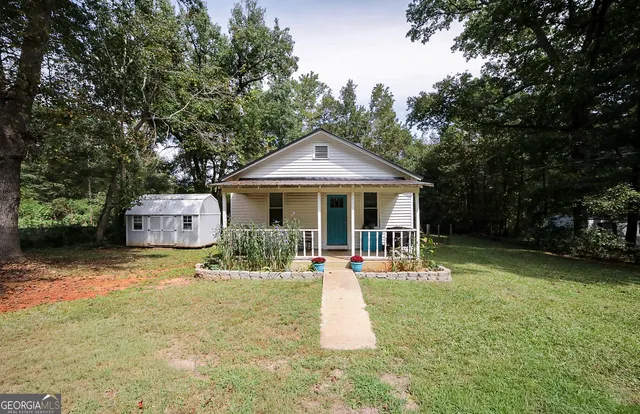 a front view of a house with a yard table and chairs
