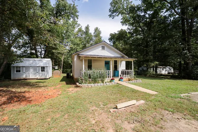 a front view of house with yard and trees
