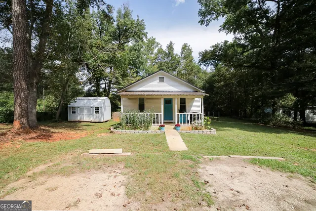 a front view of a house with a yard table and chairs