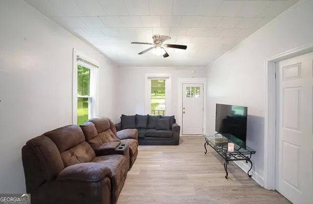 a living room with furniture and a flat screen tv
