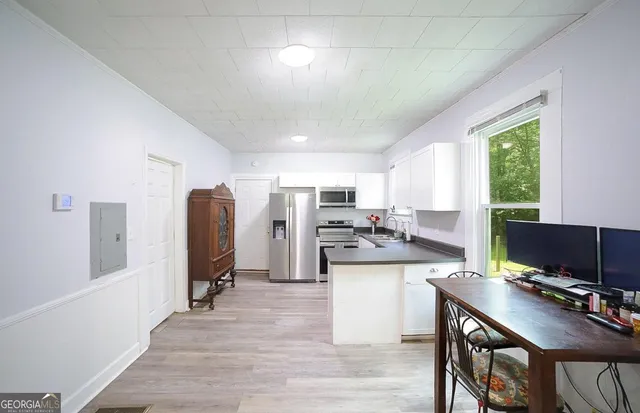 a view of a kitchen with kitchen island granite countertop a refrigerator and a stove top oven