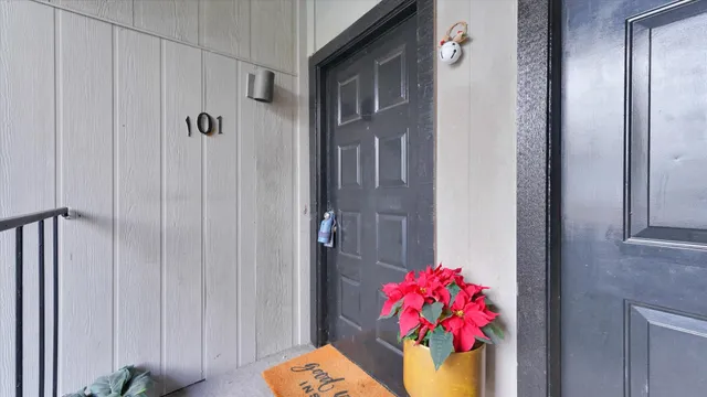 a vase of flowers sitting on a wooden floor