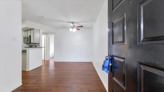 wooden floor in an empty room with a kitchen