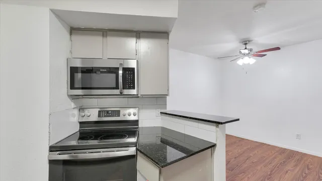 a kitchen with a stove and a microwave
