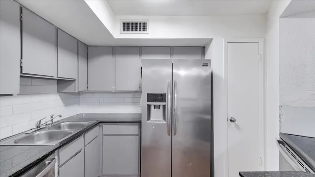 a kitchen with a sink and refrigerator