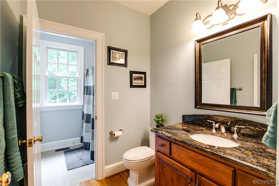 3631 Lansdowne Road Midlothian, VA 23113 - Photo 22 of 50 a bathroom with a granite countertop toilet sink and mirror