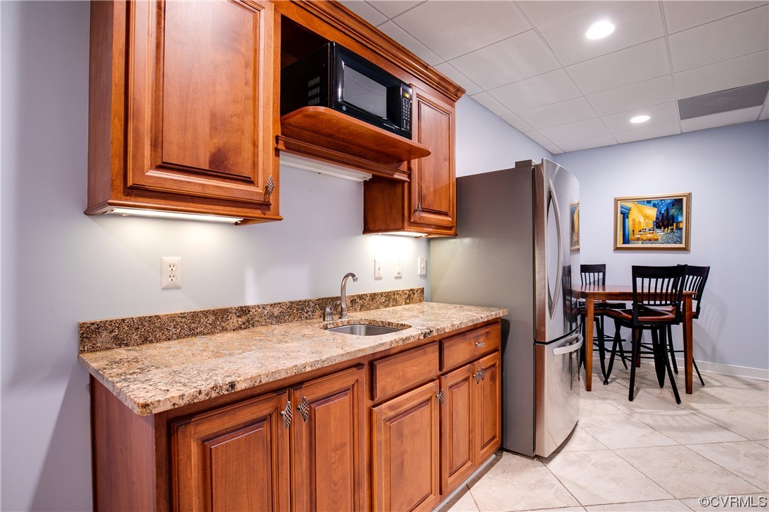 3631 Lansdowne Road Midlothian, VA 23113 - Photo 40 of 50 a kitchen with stainless steel appliances granite countertop a sink and a refrigerator