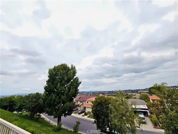 a view of a roof deck with couches and sky view