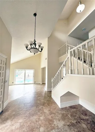 a view of a room with lots of windows and stairs
