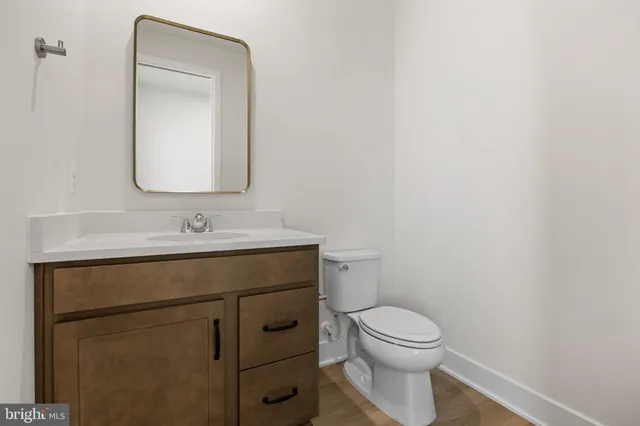 a large kitchen with stainless steel appliances a sink and cabinets