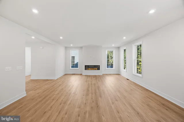 a living room with furniture and view of kitchen
