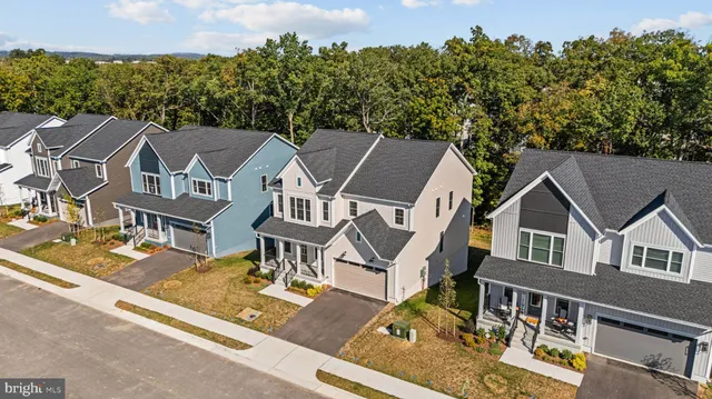 an aerial view of multiple houses with a yard