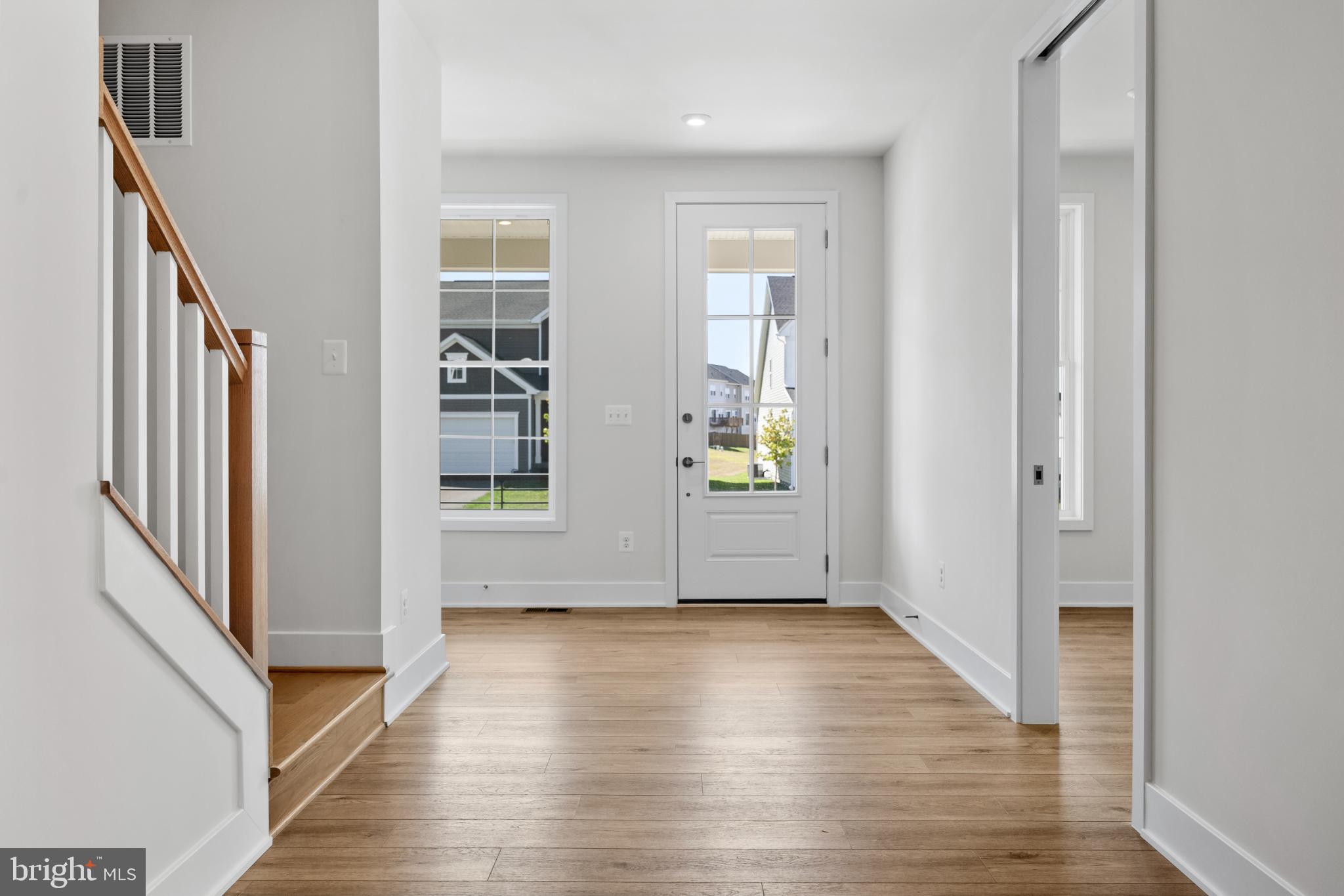 104 Alabaster Lane Stephenson, VA 22656 - Photo 21 of 41 a view of empty room with wooden floor and kitchen