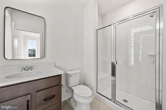 a bathroom with a granite countertop sink a toilet and a bathtub