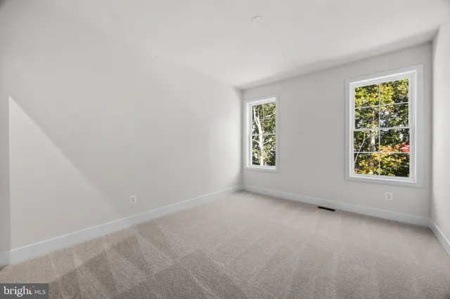 a spacious bedroom with a bed and a window