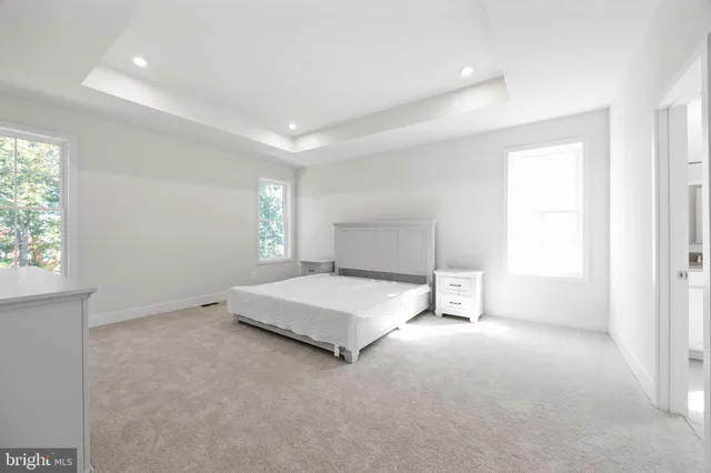 a spacious bedroom with a bed and a window