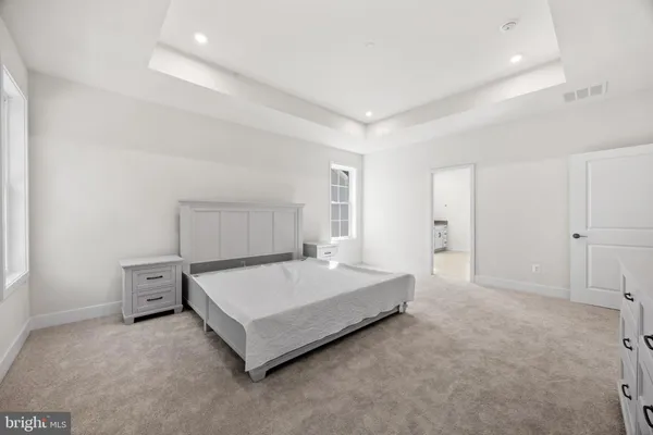 a spacious bathroom with a double vanity sink a mirror and a shower
