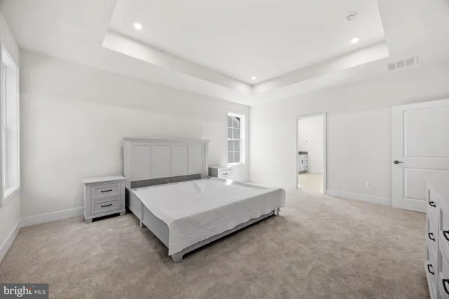 a spacious bathroom with a double vanity sink a mirror and a shower