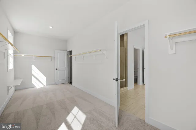 a utility room with wooden floor washer and dryer