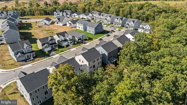 an aerial view of a residential houses with outdoor space