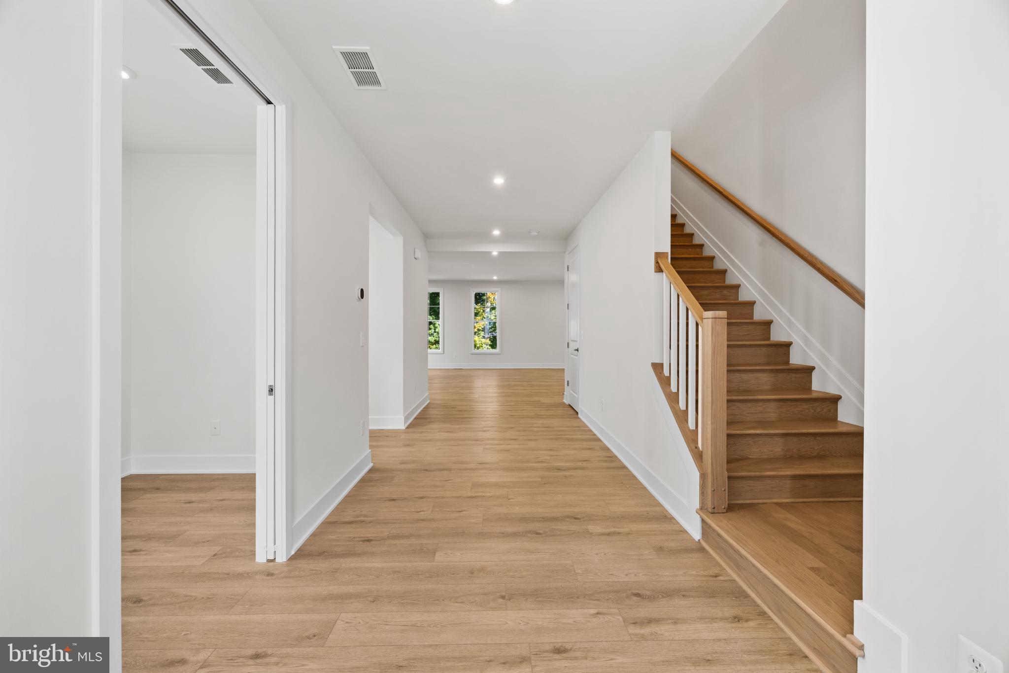 104 Alabaster Lane Stephenson, VA 22656 - Photo 9 of 41 a view of a hallway with wooden floor and staircase