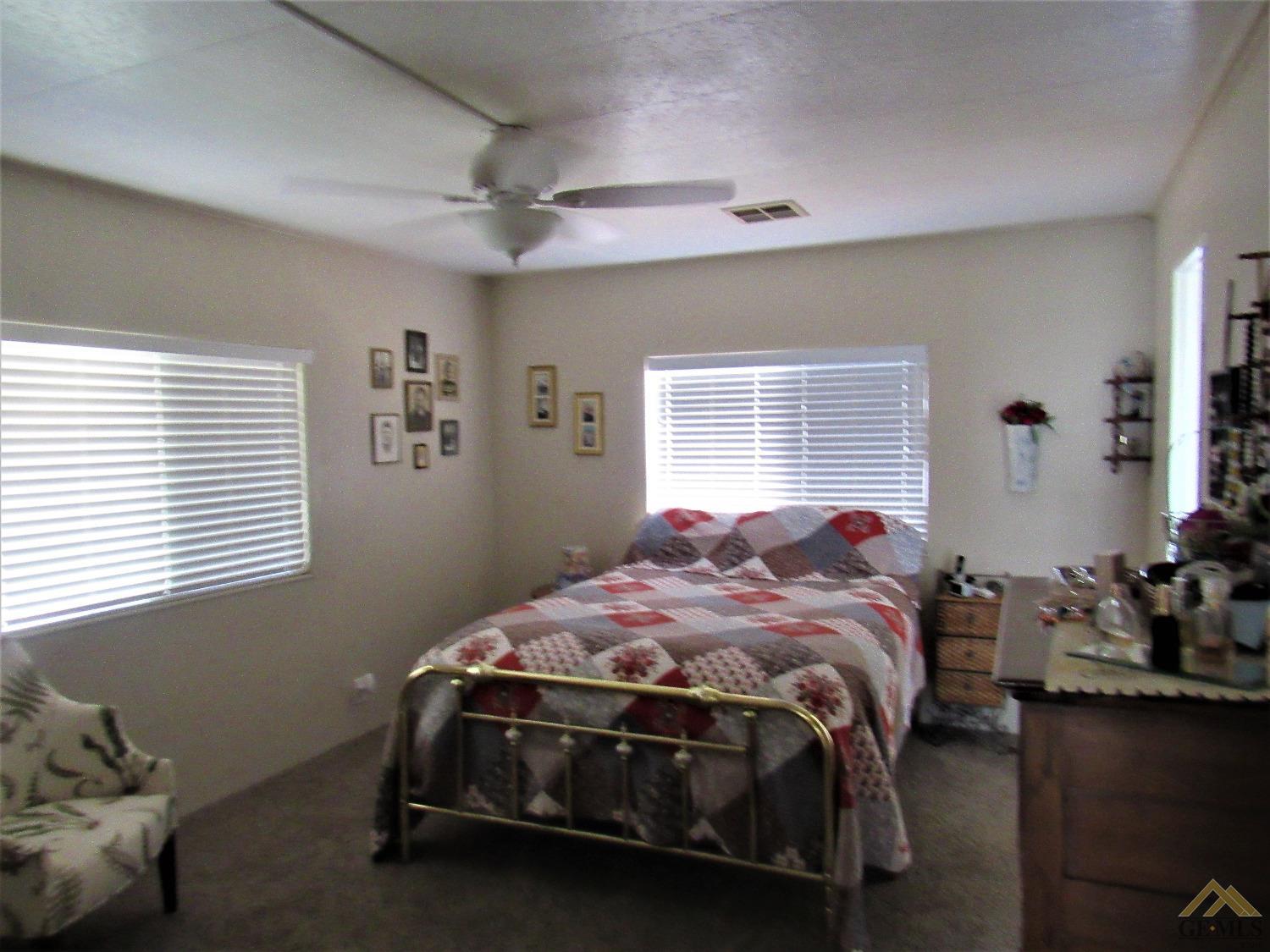Undisclosed Address Bakersfield, CA 93308 - Photo 11 of 20 a bedroom with a bed and windows