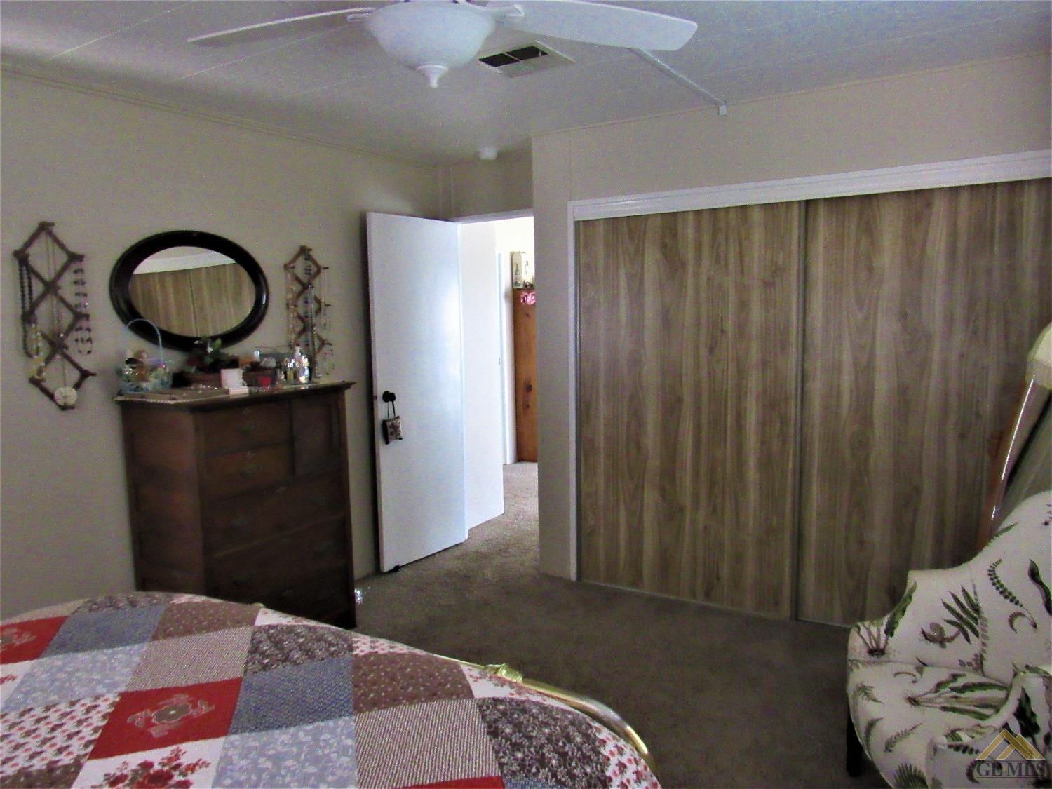 Undisclosed Address Bakersfield, CA 93308 - Photo 12 of 20 a bedroom with a bed and a dresser