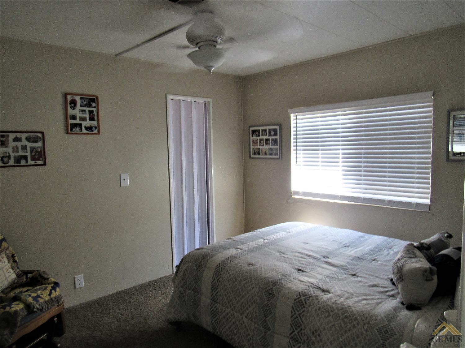 Undisclosed Address Bakersfield, CA 93308 - Photo 16 of 20 a bedroom with a bed and a window