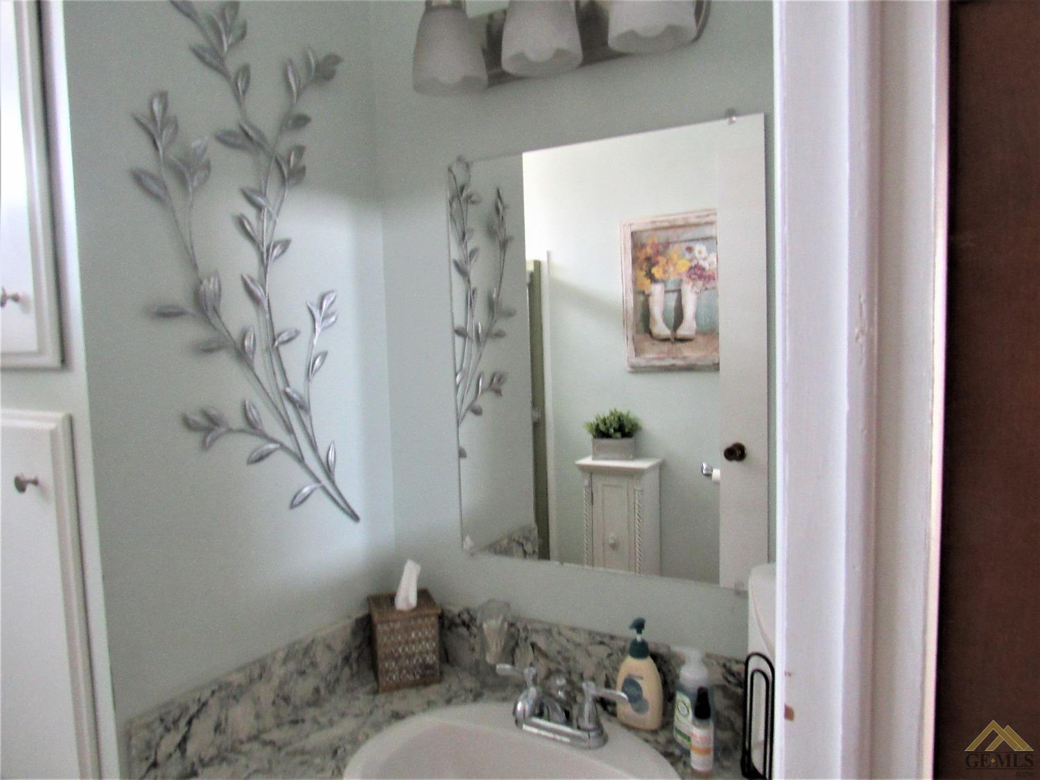 Undisclosed Address Bakersfield, CA 93308 - Photo 17 of 20 a bathroom with a sink and a mirror