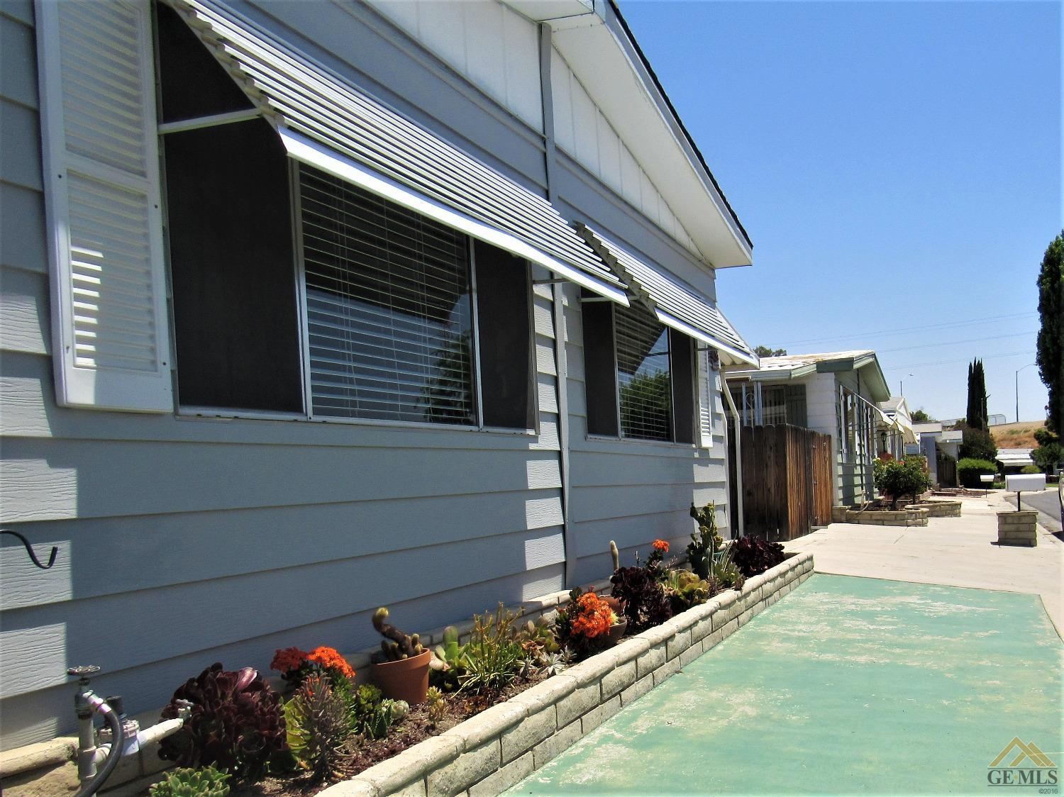 Undisclosed Address Bakersfield, CA 93308 - Photo 3 of 20 a view of a house with a yard and potted plants
