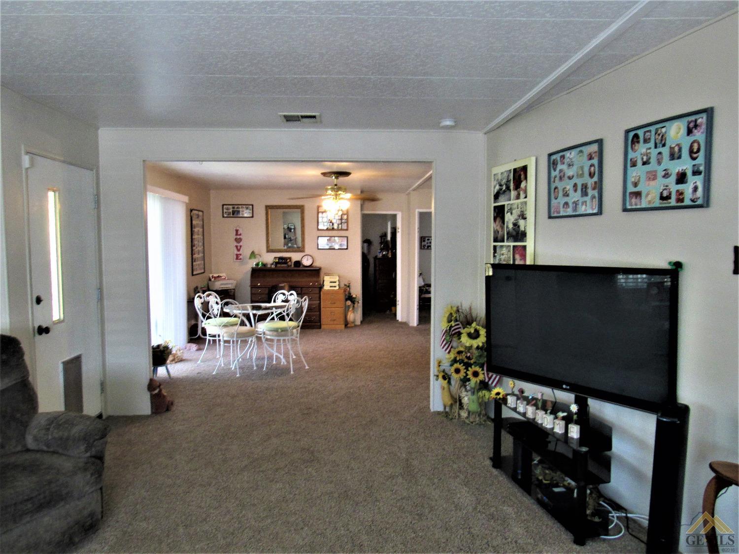 Undisclosed Address Bakersfield, CA 93308 - Photo 4 of 20 a living room with furniture and a flat screen tv